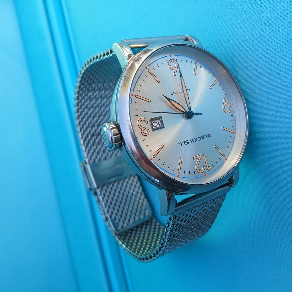 Silver and Gold Mesh Strap Watch with Round Face and Date Window